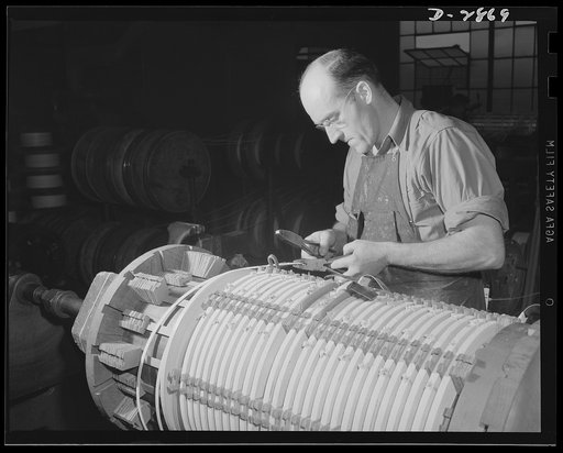 Transformer manufacture. For many years this employee of a large Eastern electrical company has been winding low voltage coils for power transformers. He's become one of Uncle Sam's valued workers, because transformers are essential to almost every phase of the armament program. Westinghouse, Sharon