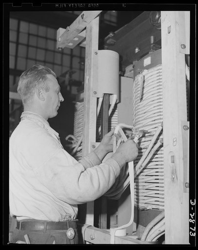 Transformer manufacture. Winding insulating tape on copper coils of a power transformer, this employee of a large Eastern electrical company is helping to supply America's armed forces with ships, guns and tanks necessary to defeat the Axis. Transformers are essential to almost every phase of the ar