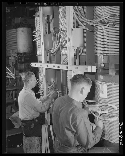 Transformer manufacture. Winding insulating tape on copper coils of a power transformer, these employees of a large Eastern electrical company are indirectly helping to supply America's armed forces with the ships, guns and tanks necessary to defeat the Axis. Transformers are essential to almost eve