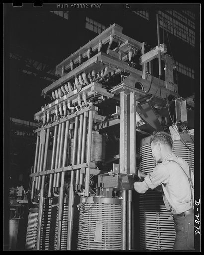 Transformer manufacture. This employee of a large Eastern electrical plant has the job of getting these big cores and coils into shape before they are lowered into steel transformer tanks and immersed in oil. Westinghouse, Sharon, Pennsylvania
