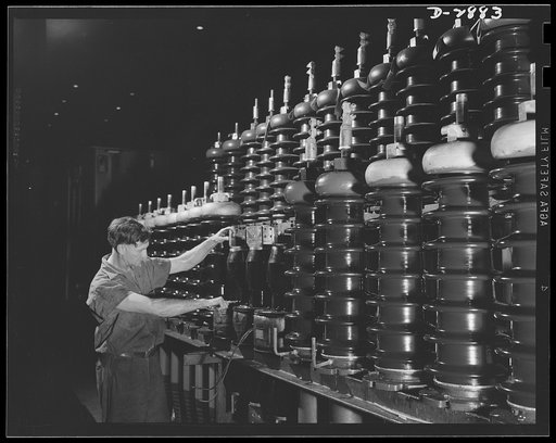 Transformer manufacture. These porcelain spirals are part of the works of a power transformer; transformers are essential to war production industries, and this employee of a large Eastern electrical company, working in the bushing section, is contributing essentially to Uncle Sam's war effort. Bush