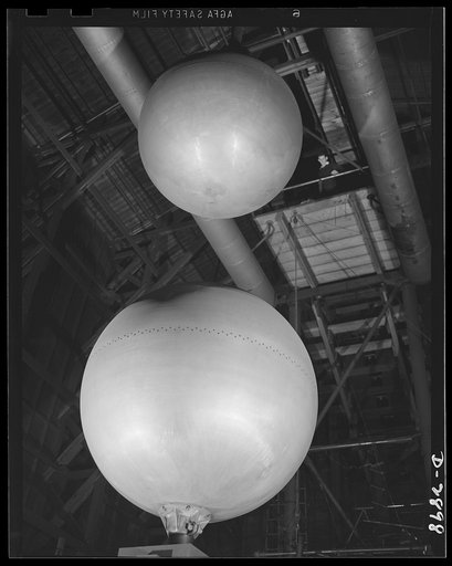 Transformer manufacture. These huge aluminum spheres are used to test each power transformer which is ready to be shipped from a large Eastern electrical plant. Since lightning is apt to destroy power units in the field, each transformer is given an "artificial lightning" test to determine its abili