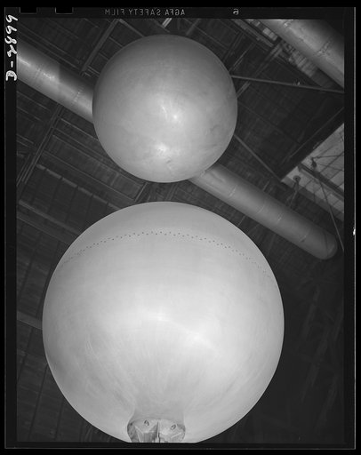 Transformer manufacture. These huge aluminum spheres are used to test each power transformer which is ready to be shipped from a large Eastern electrical plant. Since lightning is apt to destroy power units in the field, each transformer is given an "artificial lightning" test to determine its abili