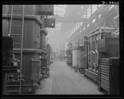 Transformer manufacture. Ready to be sent to aluminum and magnesium plants are these power transformers manufactured by a large Eastern electrical company. Along this aisle of the plant, are other transformers in every stage of manufacture. They are essential to almost every phase of Uncle Sam's war