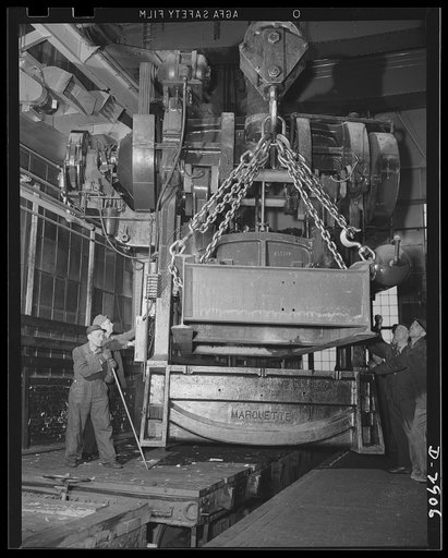 Conversion. Automobile plant. A thirty-eight-and-a-half-ton Bliss Marquette No. 40 1/2-84 press, removed from a building that is being entirely cleared and converted to other war production, is lowered to a flat car for shipment to its new location. There it will form hood sides for 4 x 4 and 6 x 6 
