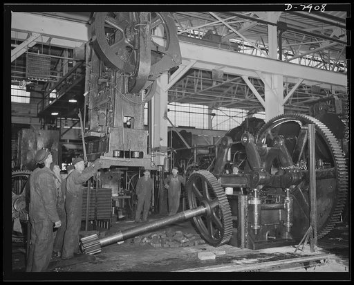 Conversion. Automobile plant. A seventeen-ton 6D Bliss press is lowered by overhead crane to the location at which it will produce door trim panels for 4 x 4 and 6 x 6 Army trucks. The press was taken from another of the plant buildings that is being entirely cleared for conversion to other war prod