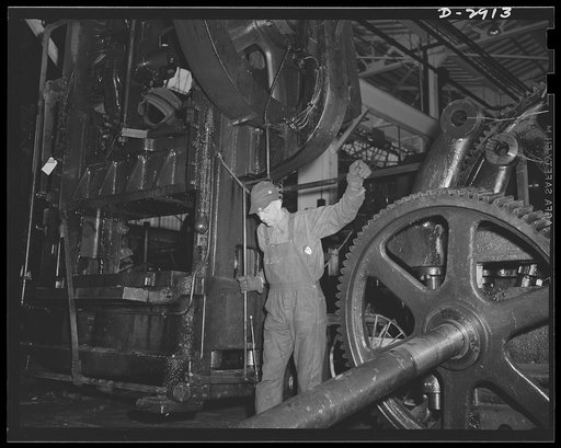 Conversion. Automobile plant. A seventeen-ton 6D Bliss press is lowered by overhead crane to the location at which it will produce door trim panels for 4 x 4 and 6 x 6 army trucks. The press was taken from another of the plant buildings that is being entirely cleared for conversion to other war prod