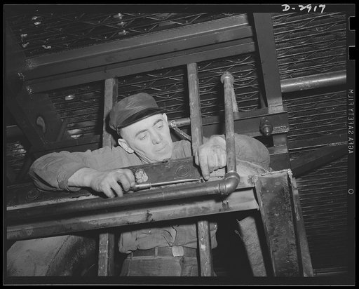 Conversion. Automobile plant. Running an electric feeder conduit from a main power panel to relocated presses in a big automobile plant. The presses will work on hood side panels of 4 x 4 and 6 x 6 army trucks. Chevrolet Motors, Detroit, Michigan