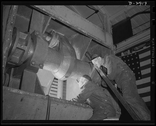 Conversion. Automobile plant. Workmen inspect the powerful crank of a DF-1600-60 press that weighs eighty-seven tons. The machine is being cleaned and adjusted before moving to its new assignment of drawing army truck parts in a former automobile factory. Chevrolet Motors, Detroit, Michigan