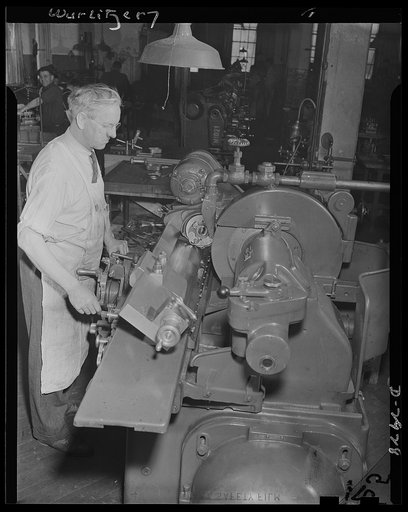 Conversion. Jukebox plant. Production of the drill jig part, pictured here, is included in the conversion of a jukebox manufacturing company to war production. Control instruments based on the jukebox selection device will be manufactured for America's armed forces. Rudolph Wurlitzer, North Tonawand