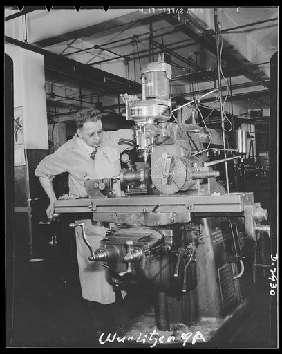 Conversion. Jukebox plant. A skilled milling machine operator, this employee of an Eastern jukebox manufacturing concern has already been given war work to do. He's aiding in production of electrical control instruments whose basic design is similar to the control device on jukeboxes. When jukeboxes