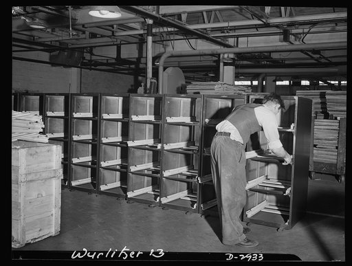 Conversion. Jukebox plant. Pinch hitting for metal, wood is now used in production of file cabinets in wartime America. Slides are among the few metal parts used in this manufacture and can be clearly seen in the picture. This shot was taken in an Eastern jukebox manufacturing concern whose producti