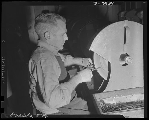 Conversion. Silverware plant. Normally used in the manufacture of fine silverware, this grinder is now used in production of surgical instruments, as an Eastern factory undergoes conversion to the production of materials essential to Army and Navy medical corps. Oneida Ltd., Oneida, New York