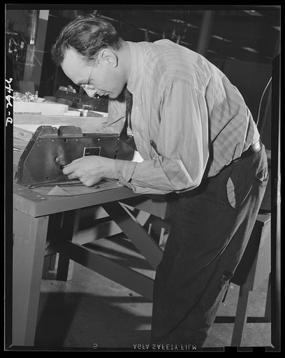 Conversion. Silverware plant. Erstwhile polisher of fine silverware, this employee of an Eastern plant now undergoing conversion to production of war essentials, is at present engaged in assembly of bomb shackles. More than 500 operations on 100 parts are required to assemble the shackles. And incid