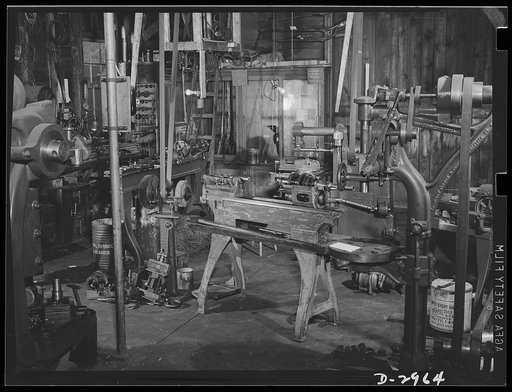 Subcontracting (Beery and Sons). Plant conversion means machine conversion. This lathe at the Beery and Sons shop in Harrisonburg, Virginia, is being fitted for production of a small part needed by a war contractor. To the left of the lathe are some of the hurriedly constructed jigs and chucks turne