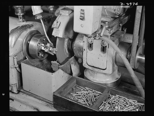 Conversion. Electric shaver plant. This Norton type C six-inch semi-automatic cylindrical grinder in a New England plant normally turns out these motor shafts for the firm's electric shavers. It has since been converted to the grinding of spring collets that are used in machine tools being produced 