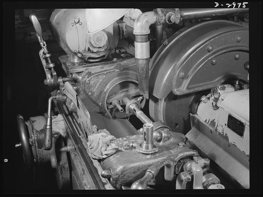 Conversion. Electric shaver plant. This Norton type C six-inch semi-automatic cylindrical grinder in a New England plant used to grind motor shafts for the firm's normal production of electric dry shavers. It is now grinding spring collets which are used in turning machines to hold the work being tu