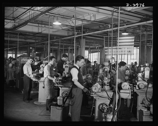 Conversion. Electric shaver plant. This New England whose normal product is electric dry shavers is now turning out parts for machine tools which will find their place in the war production effort. This bank of Norton grinders which formerly ground motor shafts are now grinding small parts for tools