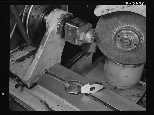 This Norton cutter-grinder which had been specially adapted to grind cams on the motor shaft for the electric dry shaver which this New England plant normally produces, has now been converted to grind permanent magnet rotors for machine tool motors. The conversion was accomplished with new jigs and 