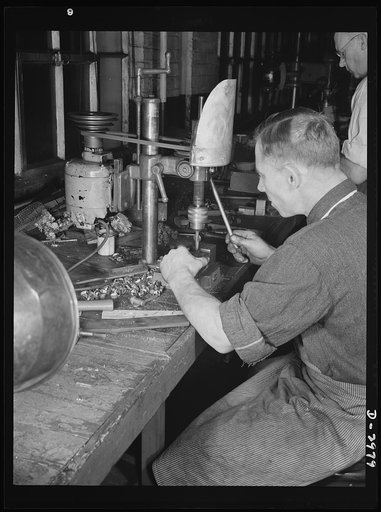 Conversion. Electric shaver plant. This New England plant normally produces electric dry shavers. On this drill press the heads of the shavers are drilled before slotting to form the rack. Drill presses and other productive machines have now been converted to war production. Schick Inc., Stamford, C
