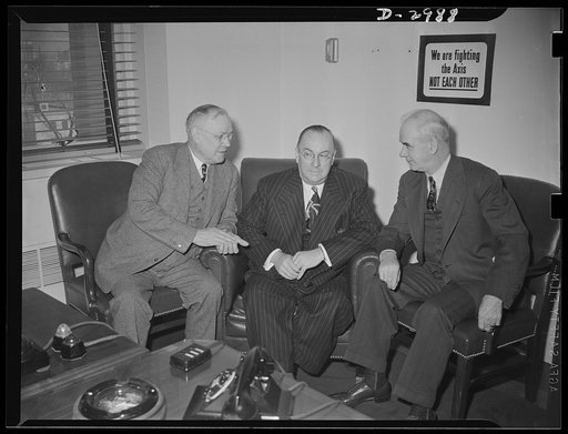 Washington, D.C., March 7, 1942. Donald Nelson, Chairman of the War Production Board meets with the nation's leaders to discuss plans for the production drive. Left to right: William Green, President of the AFL (American Federation of Labor); Donald Nelson, Chairman of the War Production Board; Phil