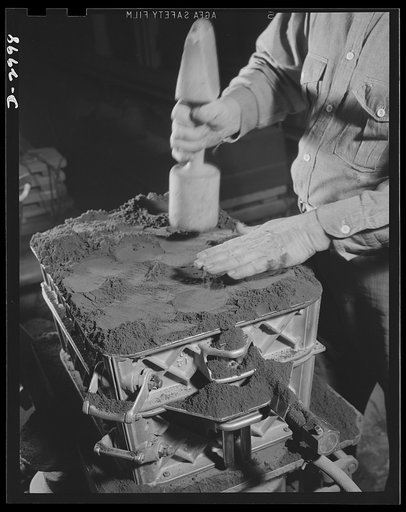 Aluminum casting. One of the skilled workers in an aluminum foundry pictured ramming the drag side of a sand mold. This foundry is producing aluminum equipment for Uncle Sam's war effort, under subcontract to other factories producing war items. Aluminum Industries Inc., Cincinnati, Ohio