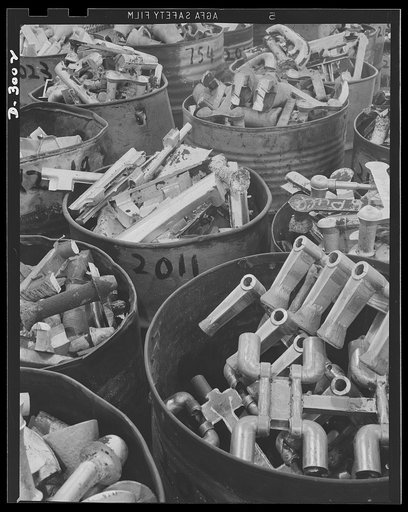 Aluminum casting. Gates and risers--extraneous materials from earlier castings ready to be remelted and recast. Aluminum Industries Inc., Cincinnati, Ohio
