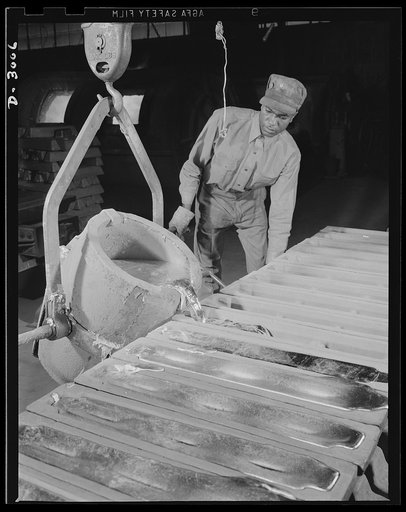 Aluminum casting. Bright white hot aluminum, vital to Uncle Sam's war effort, discharged from carrying pot into ingot molds. Aluminum Industries Inc., Cincinnati, Ohio