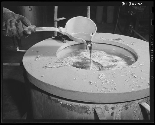 Aluminum casting. Hundreds of delicate operations are required before aluminum parts for Uncle Sam's Army and Air Corps can be acquired. Here excess aluminum alloy is poured into a holding pot. Aluminum Industries Inc., Cincinnati, Ohio