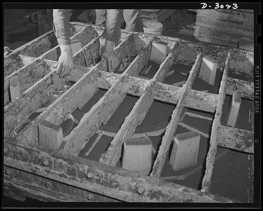 Aluminum casting. Before metal can be poured into the mold, this wooden superstructure will be completely filled with sand. Technically, it's known as facing sand on coperflask and placing of gaggers. But in anybody's language, it's one of the many operations necessary to complete molds in which vit