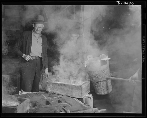 Aluminum casting. Uncle Sam's soldiers on the production lines of defense pour a large magnesium casting. The molten alloy enters the runner box first. Magnesium is one of the most valuable metals for war production. Exact purpose of this casting is kept secret. Aluminum Industries Inc., Cincinnati,