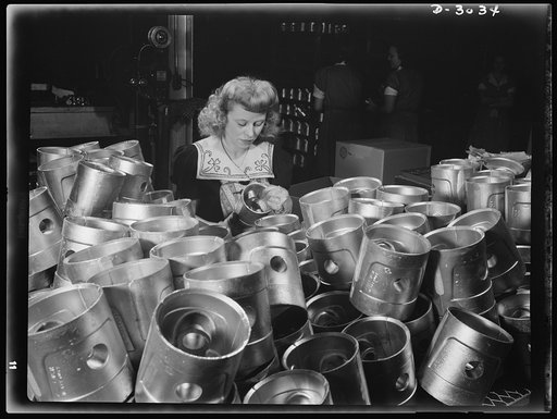 Aluminum casting. Womens' place in this large Midwest aluminum factory is on the inspection line. She's giving a final checkup on these aluminum pistons which are destined for use by America's armed forces. Destination of the finished aluminum products is kept secret. They'll probably end up as jeep