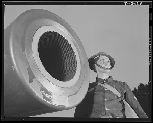 Fort Story coast defense. Representatives of America's men and machines who are out to blast the Axis. Note lands and grooves on interior of muzzle. These bite into the copper rotating band near the base of the projectile and start it spinning as it leaves the gun. This motion keeps the shell on a t