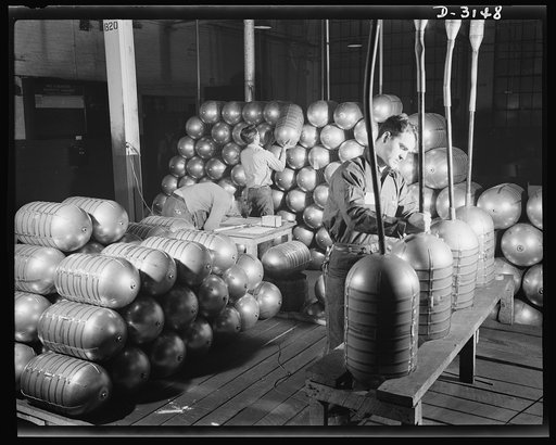 Conversion. Beverage containers to aviation oxygen cylinders. After shatterproof oxygen cylinders for high altitude flying have passed all tests in the metal division of a large Eastern rubber factory, hot air is blown through the cylinders to remove all trace of moisture (left). The cylinders are t