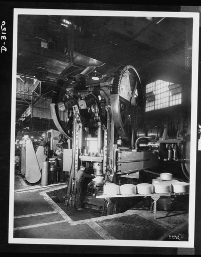 Conversion. Beverage containers to aviation oxygen cylinders. The huge press which formed the beverage containers shells pictured here has since been converted to produce oxygen cylinders, required by the U.S. Army for high altitude flying. The conversion was accomplished by substituting new dies. F