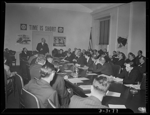 Donald M. Nelson, Chairman of the War Production Board, addressing the Conversion Conference of Business Paper editors and publishers with War Production Board officials in Washington, D.C.