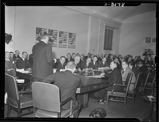 Donald M. Nelson, Chairman of the War Production Board, addressing the Conversion Conference of Business Paper editors and publishers with War Production Board officials in Washington, D.C.