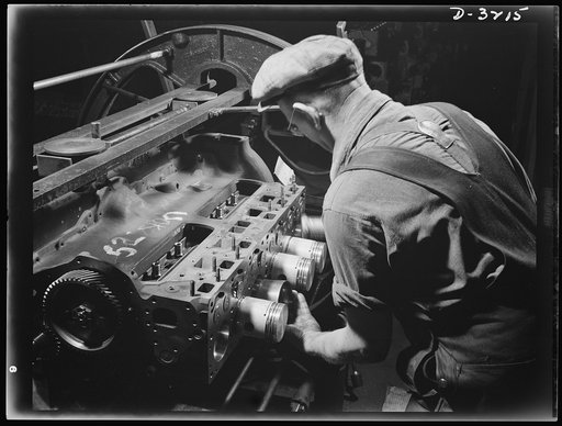 Halftrac scout cars. Putting precision-made pistons assemblies into precision-made cylinders is a job that fits this former auto worker. The engine will be the power plant of an Army halftrac scout car. The Midwest plant that is turning it out has trained American automotive workers for every job on