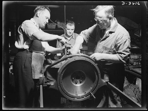 Halftrac scout cars. When the American assembly line gets down to business, things gets done and done well. The assembling of engines for the Army's new halftrac scout cars is a job well done and understood by the trained men of a large Ohio truck plant. White Motor Company, Cleveland, Ohio