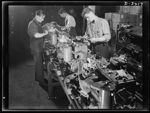 Halftrac scout cars. When the American assembly line gets down to business, things gets done and done well. The assembling of engines for the Army's new halftrac scout cars is a job well done and understood by the trained men of a large Ohio truck plant. White Motor Company, Cleveland, Ohio