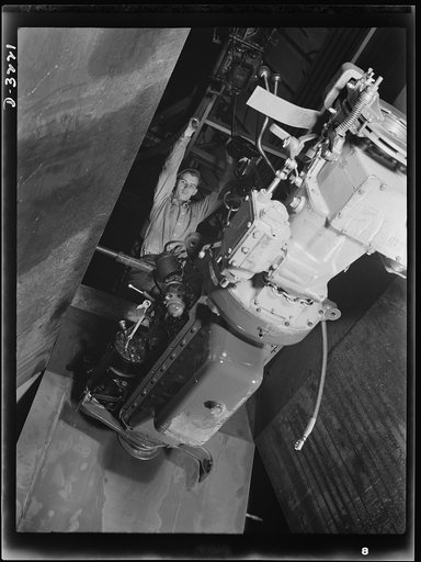 Halftrac scout cars. It won't be long before this capable-looking engine becomes the power plant of a halftrac scout car. Right now it's being hoisted to the assembly floor of a Midwest truck plant turning out a large order for the Army. White Motor Company, Cleveland, Ohio
