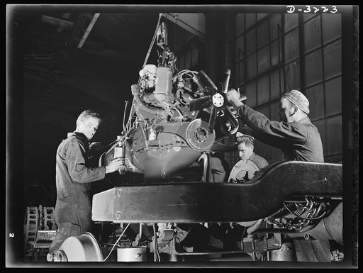 A rugged, efficient power plant goes aboard the chassis of a halftrac scout car an Ohio truck plant is producing for our new mechanized Army. White Motor Company, Cleveland, Ohio