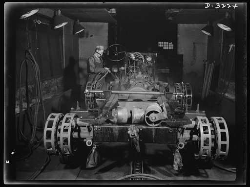 A coat of paint makes anything look better. But the purpose of spraying the undercarriages of the Army's halftrac scout cars is for protection. The job is part of the production routine on a large order being filled by a Midwest truck manufacturer. White Motor Company, Cleveland, Ohio