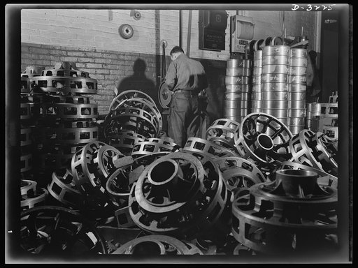 No chances are taken with the quality of wheel castings for the Army's new halftrac scout cars. This workman in an Ohio truck plant is putting the castings through an inspection routine that will weed out the weak sisters. White Motor Company, Cleveland, Ohio