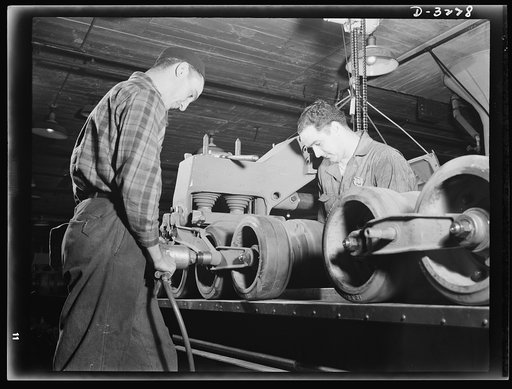 The bogy assembly of an Army halftrac scout car plays an important part in a very capable vehicle. It requires skilled workers on the production line of a large Midwest truck plant. White Motor Company, Cleveland, Ohio