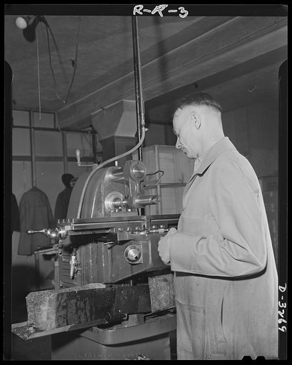 Oil burners to machine gun parts. Oil burners are the normal product of this Eastern factory now undergoing conversion to production of small precision parts for machine guns. This machine has been converted to production of gun parts. Reif-Rexoil Company, Buffalo, New York
