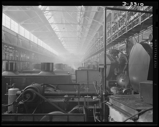 A line of forges that seem endless is turning out a stream of shells that is endless. The auto manufacturing plant that used these same forges for car parts is now on a full wartime production basis. Oldsmobile, Lansing, Michigan