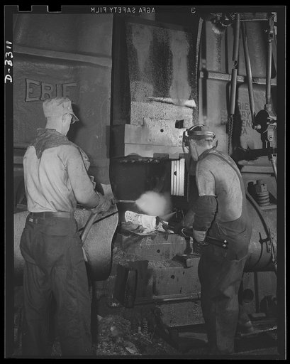 The good machines of America's arsenal of democracy must have good men to work them. The power hammer that forges shells for the Army is operated by experienced hammer-smiths who, a short time ago, were turning out parts for a well-known American automobile. Oldsmobile, Lansing, Michigan