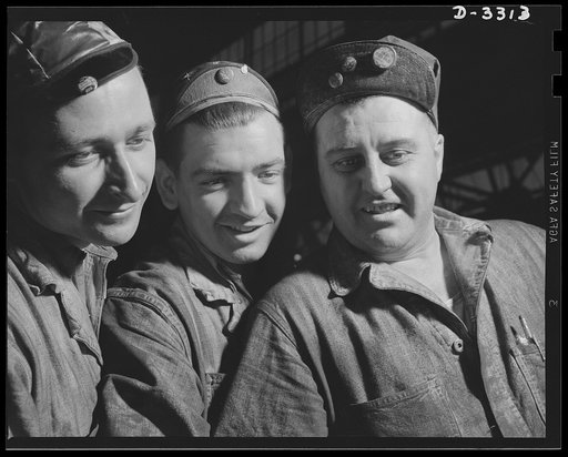 Their brawn and their skill serve democracy in the forge plant of an automobile factory now working full capacity on production of shells for the Army. Oldsmobile, Lansing, Michigan