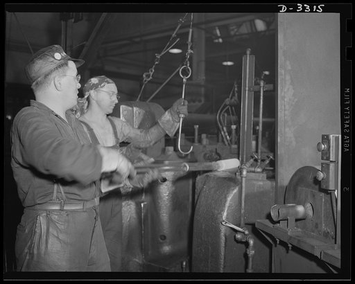A number of forging operations are required to produce a shell for the Army. Experienced auto plant workers do this work as efficiently as they did parts for the family car. Oldsmobile, Lansing, Michigan